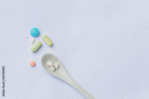 tablets on a spoon close-up on a white background