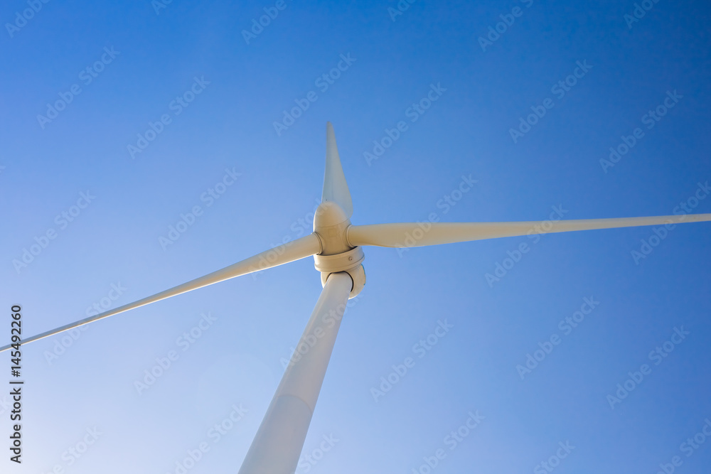 Wind turbine generating electricity with blue sky - energy conservation concept Wind turbine generating electricity with blue sky - energy conservation concept