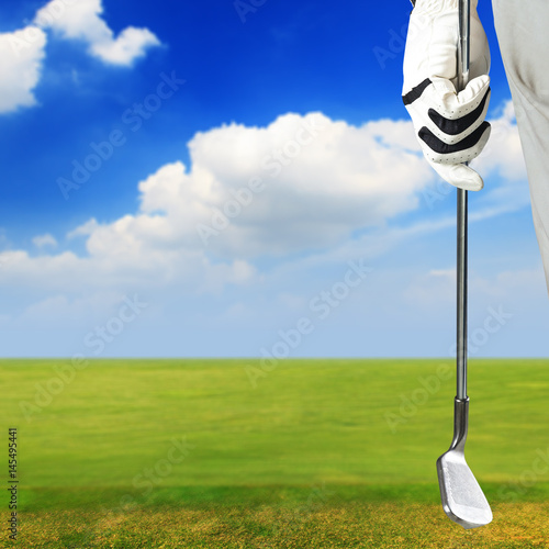 Golf player holding a golf club in golf course