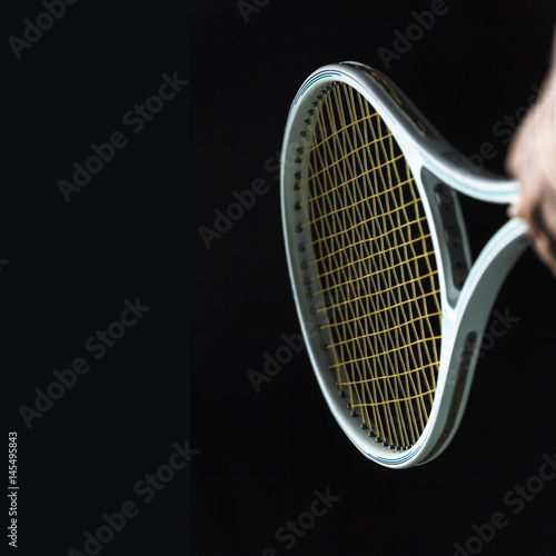 Tennis racket on black background © Naypong Studio