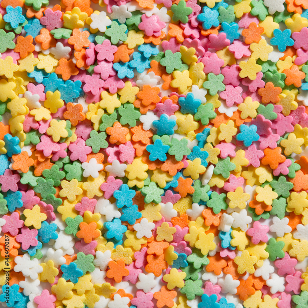 Pile of colorful flower sprinkles for cupcakes and ice-cream. Top view,  overhead Stock Photo