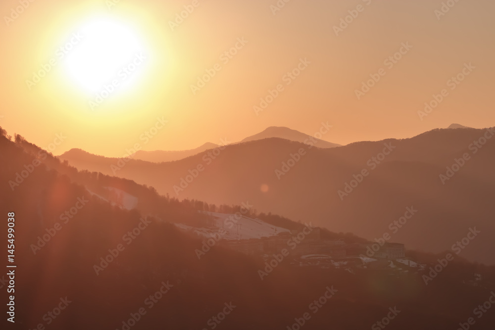 Golden rays of the sun at sunset in the mountains