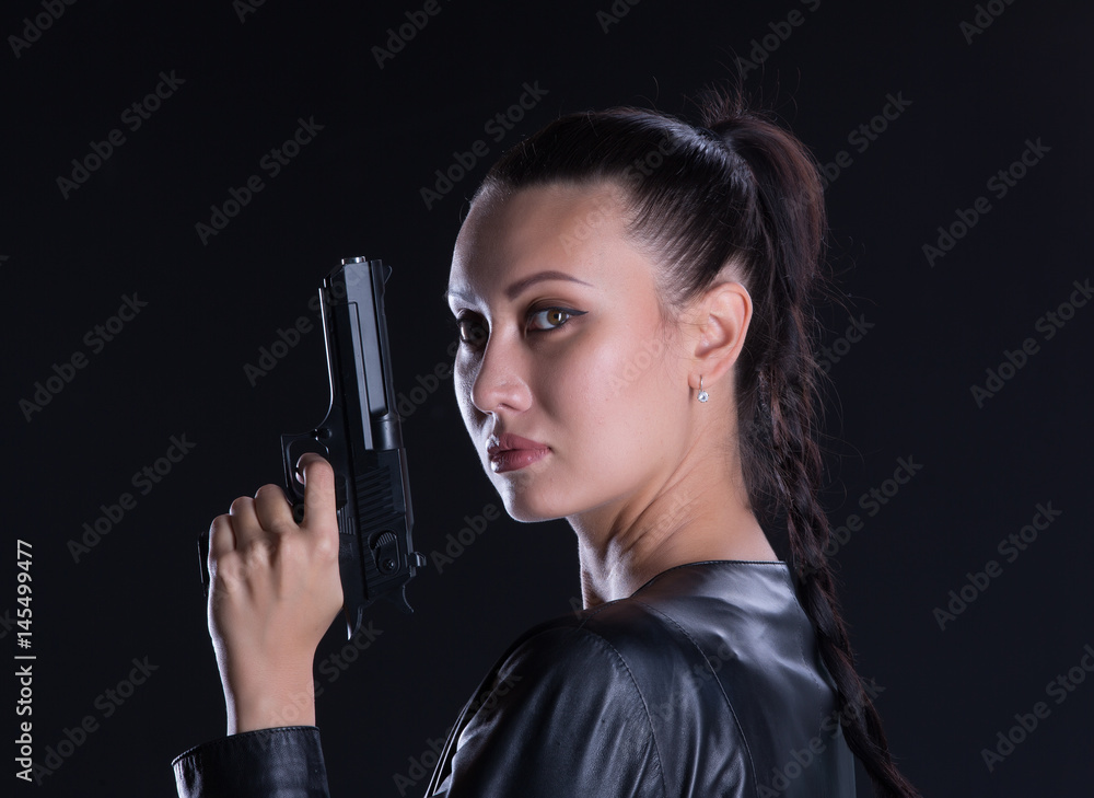 Sexy girl killer, brunette with a gun Sexy girl killer, brunette with a gun