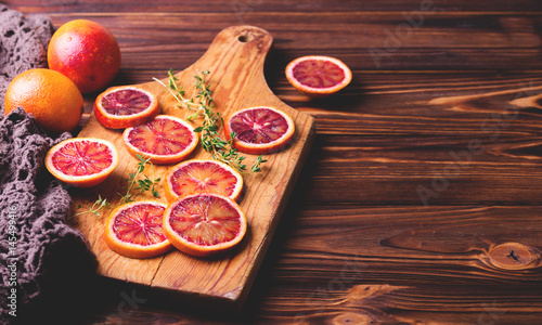 Citrus fruit background with sliced red bloody oranges