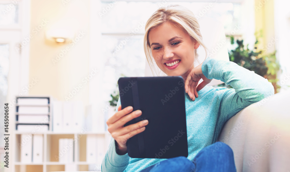 Young woman using her tablet computer Young woman using her tablet computer