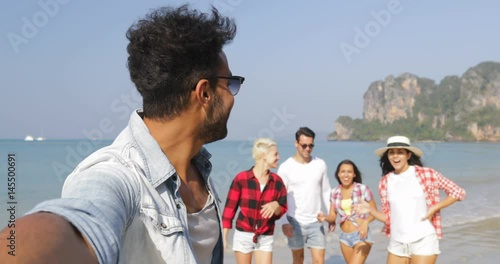 Latin Man Welcome People Group To Take Selfie Photo On Beach On Cell Smart Phone Happy Cheerful Tourists On Vacation Slow Motion 60