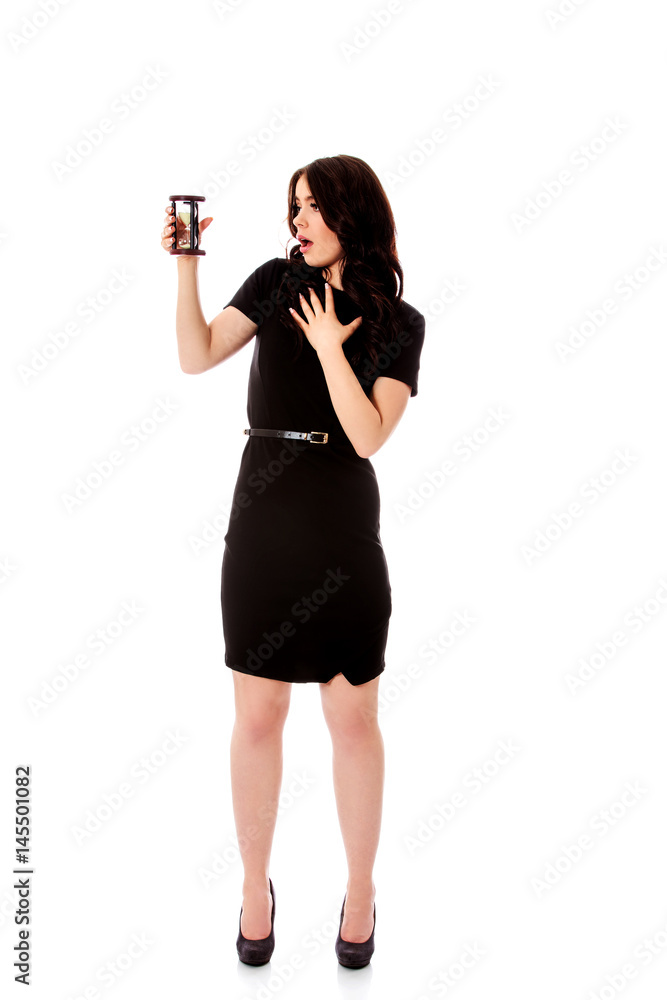 Young business woman with hourglass - time concept Young business woman with hourglass - time concept