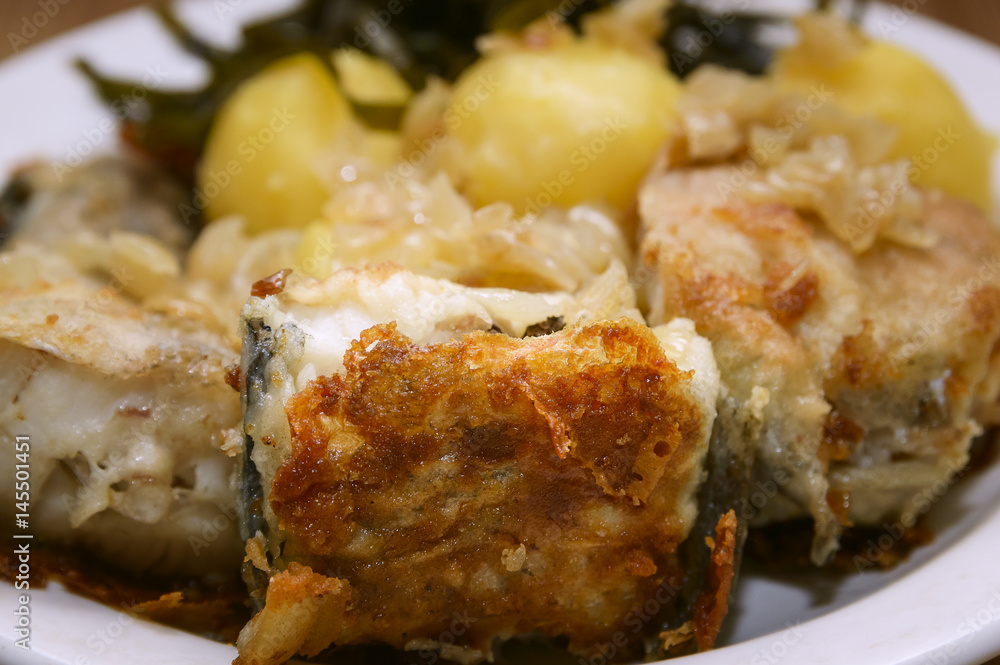 Fried fish and boiled potatoes on a plate. Fried fish and boiled potatoes on a plate.
