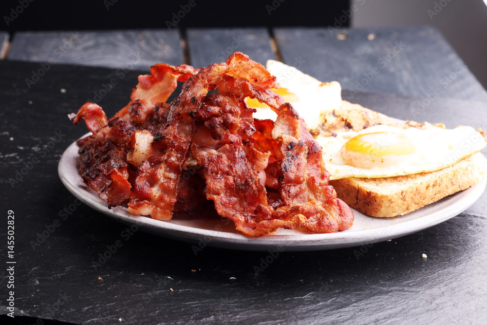 Ham and Egg. Bacon and Egg. Salted egg and sprinkled with black pepper. English breakfast. Ham and Egg. Bacon and Egg. Salted egg and sprinkled with black pepper. English breakfast.