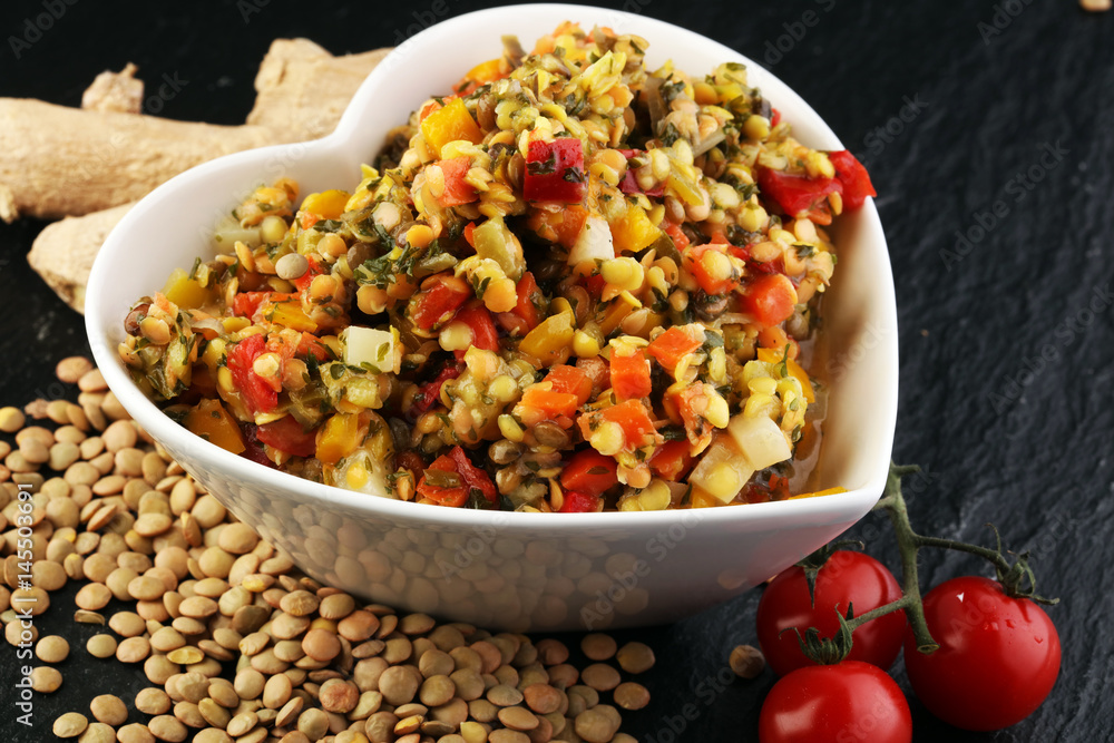 Lentil with carrot and pumpkin ragout in a wooden bowl on a wooden background Lentil with carrot and pumpkin ragout in a wooden bowl on a wooden background
