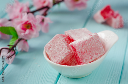 Rose flavored rahat lokum Turkish delight on wooden background. Selective focus. Ramadan food