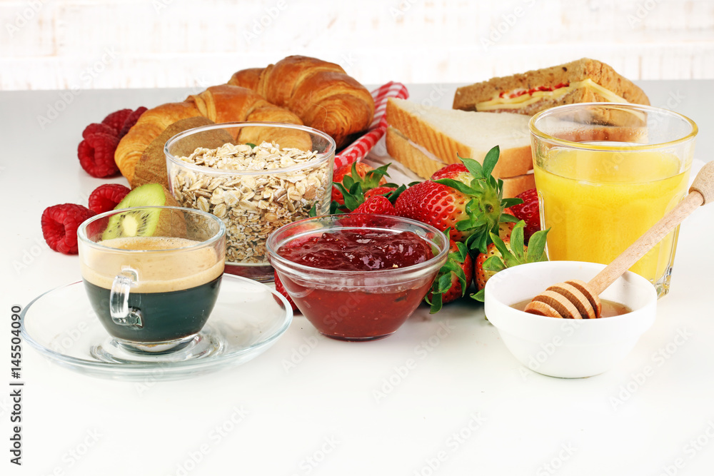 breakfast on table with sandwiches, croissants, coffe and juice breakfast on table with sandwiches, croissants, coffe and juice