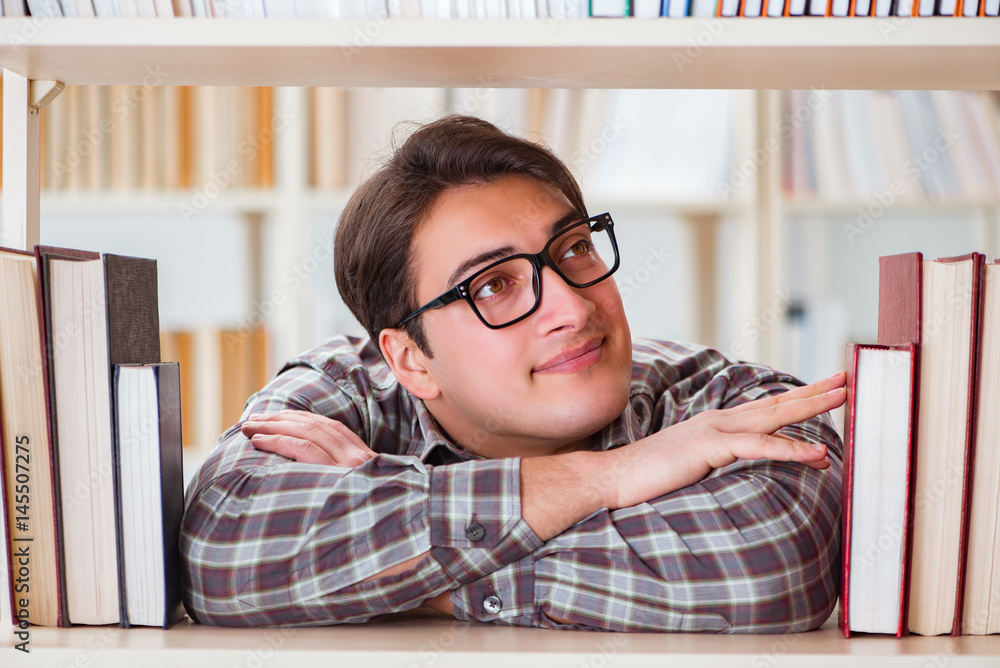 Young student looking for books in college library Young student looking for books in college library