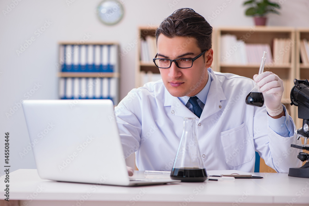 Young lab assistan working in the laboratory Young lab assistan working in the laboratory