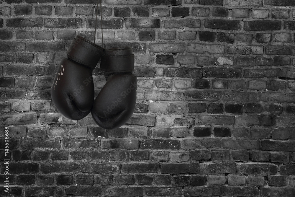Fototapeta boxing gloves on a brick wall background