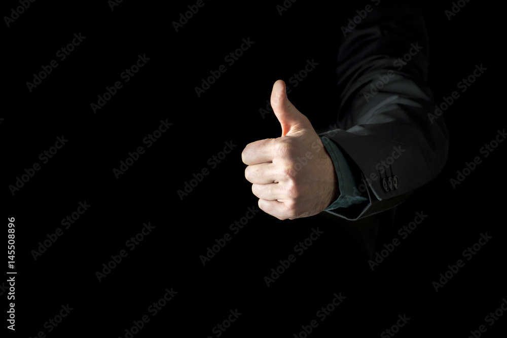 Hand of a businessman wearing black business suit showing thumb up Hand of a businessman wearing black business suit showing thumb up