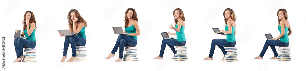 Student with netbook sitting on books Student with netbook sitting on books