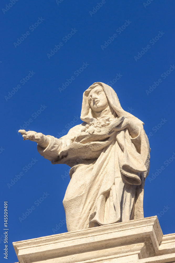 Statue. Famous colonnade of St. Peter's Basilica in Vatican City, Rome, Italy