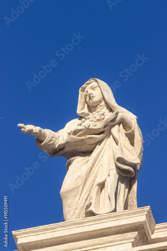 Statue. Famous colonnade of St. Peter s Basilica in Vatican City  Rome  Italy