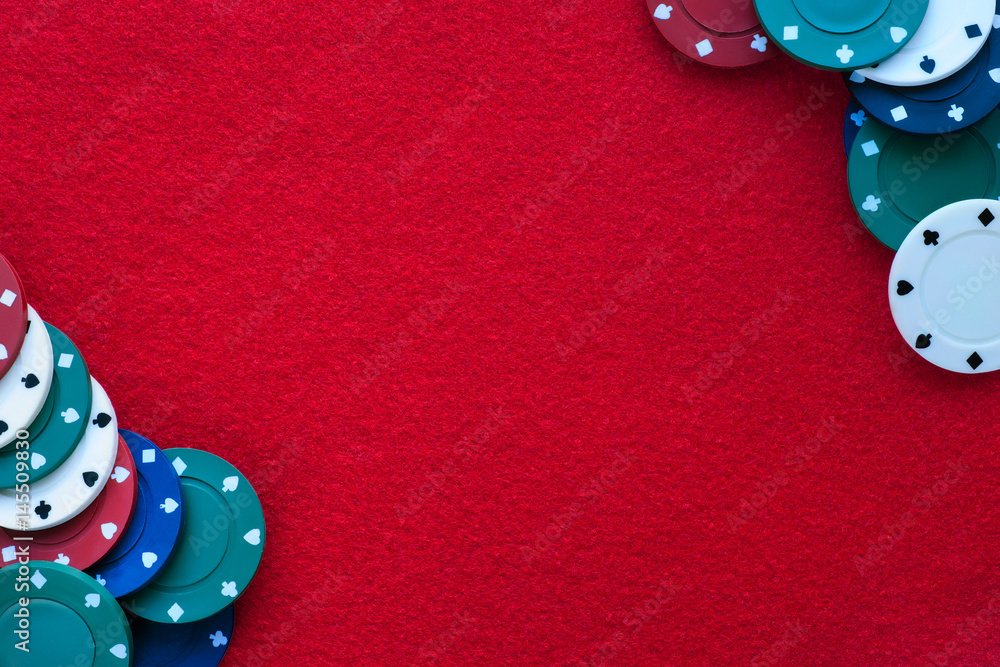 Red felt table with poker chips over it and copy space. Casino, gambling, poker and roulette theme