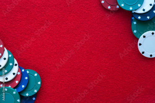 Obraz na płótnie Red felt table with poker chips over it and copy space. Casino, gambling, poker and roulette theme w salonie