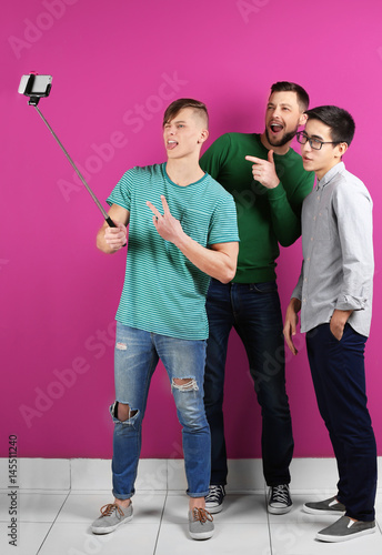 Three diverse young men tak...