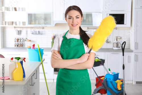 Young female cleaner at wor...