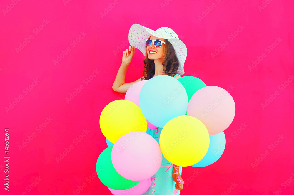 Fashion happy pretty smiling woman with an air colorful balloons is having fun in summer over pink background Fashion happy pretty smiling woman with an air colorful balloons is having fun in summer over pink background