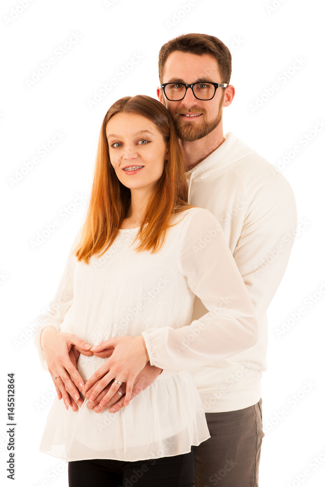 Beautiful pregnant woman and man standing isolated over white - happy couple Beautiful pregnant woman and man standing isolated over white - happy couple