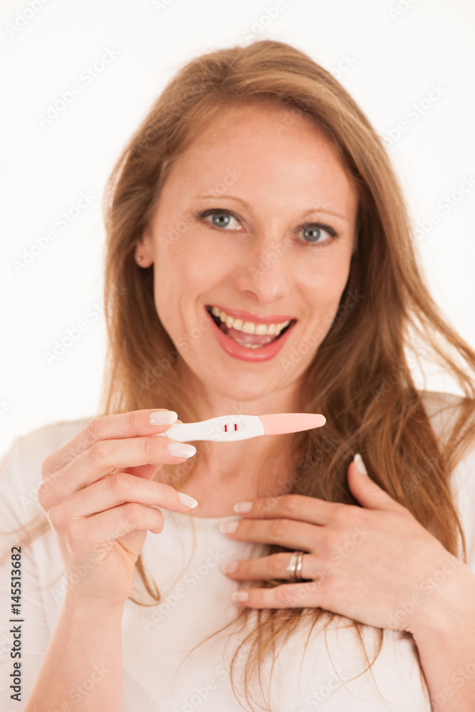 Happy woman with pregnancy test isolated over white background Happy woman with pregnancy test isolated over white background