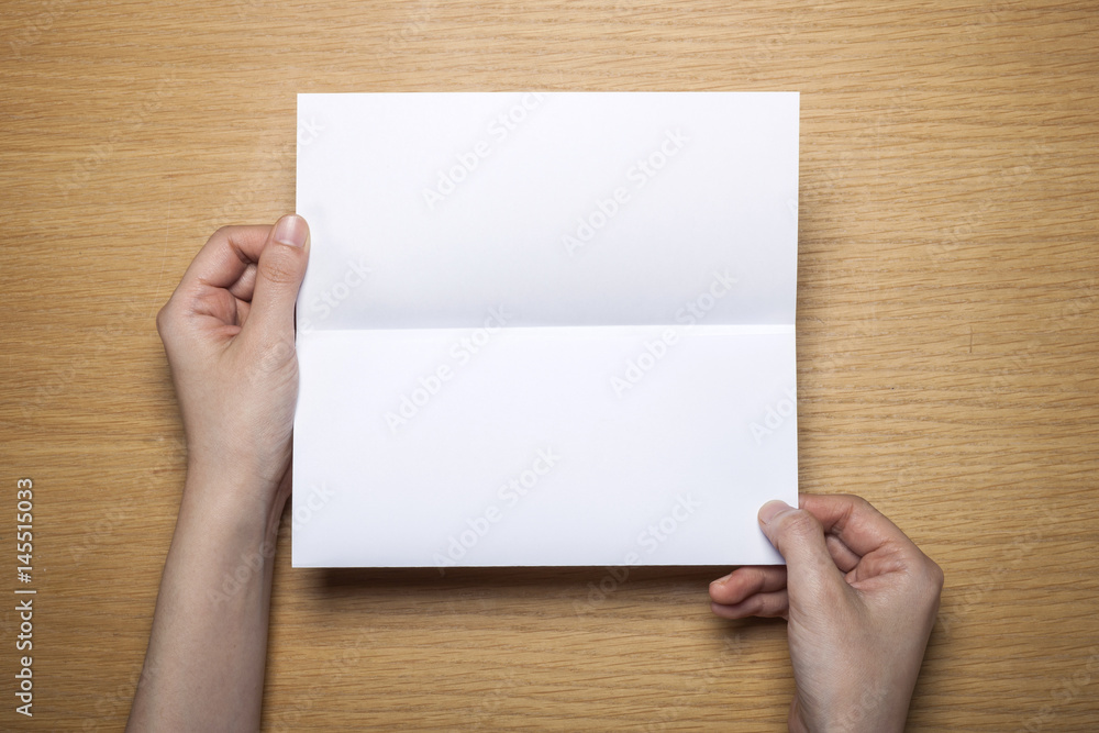 woman hand hold a letter with envelope on the wood table. woman hand hold a letter with envelope on the wood table.