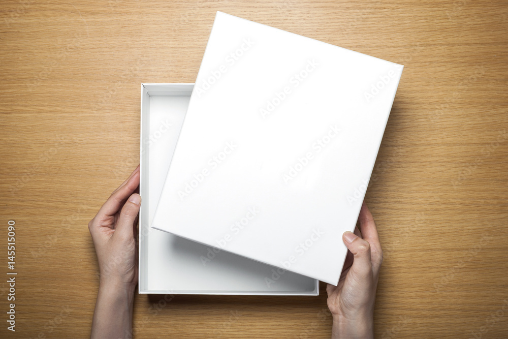 woman hand hold a paper on the wood table(background) woman hand hold a paper on the wood table(background)
