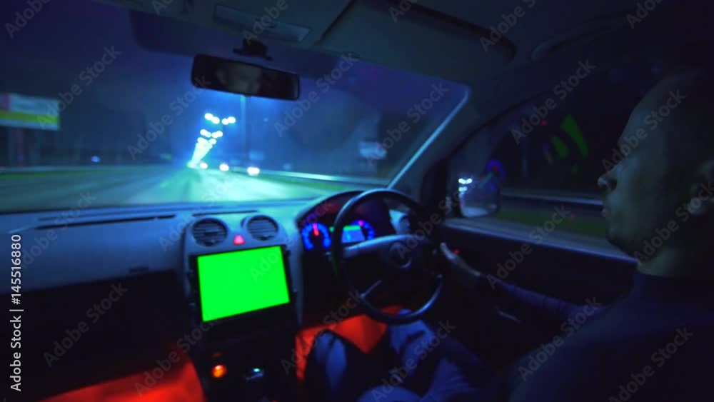 The man drive a vehicle in the night autobahn. left side traffic, wide angle, green screen display, real time capture The man drive a vehicle in the night autobahn. left side traffic, wide angle, green screen display, real time capture
