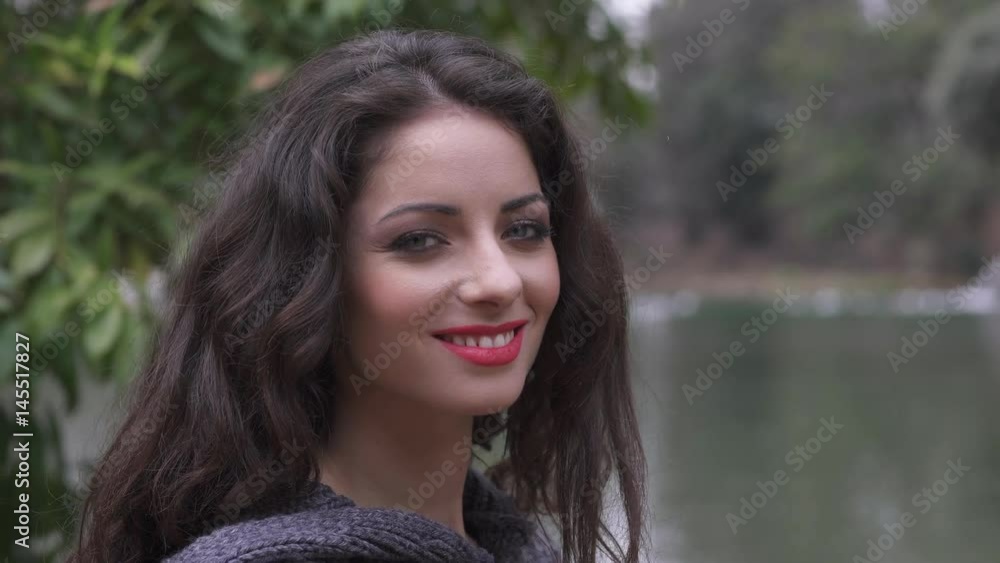 Young cute girl turns and smiles at the camera. Pretty woman smile portrait Young cute girl turns and smiles at the camera. Pretty woman smile portrait