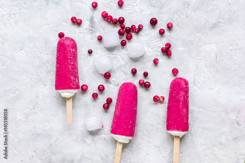 homemade ice-cream with cowberry stone table background top view