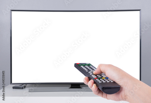 Hand holding TV remote control with LED TV and white screen photo