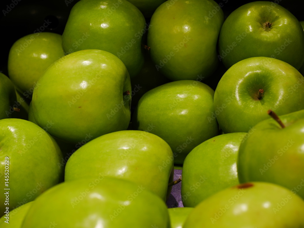 Closeup of many green juicy apple fruits in market Closeup of many green juicy apple fruits in market