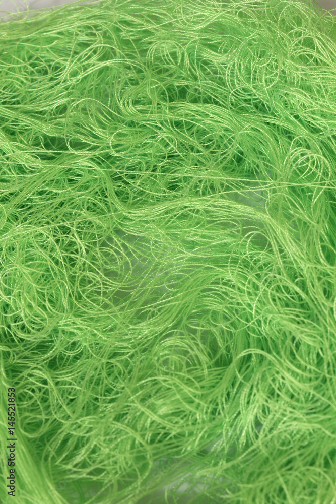 Green sewing thread roll background Green sewing thread roll background