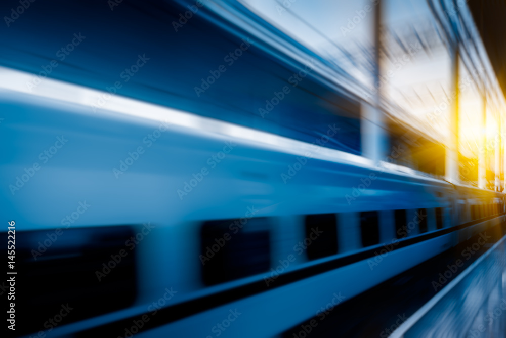 Blurred view of train leaving platform in city of China.