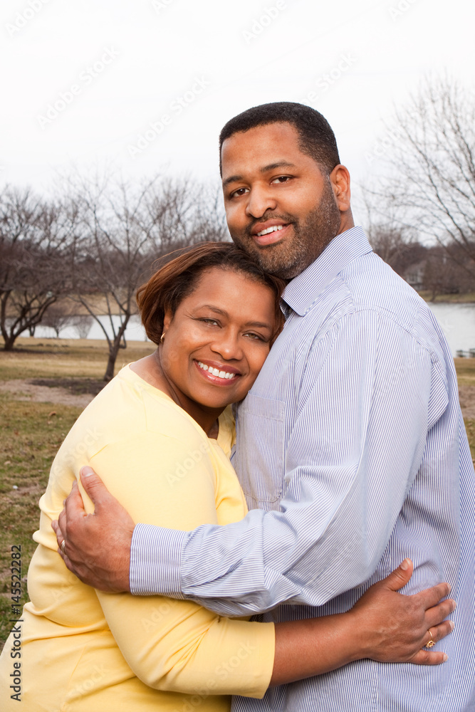 Mature African American couple laughing and hugging. Mature African American couple laughing and hugging.