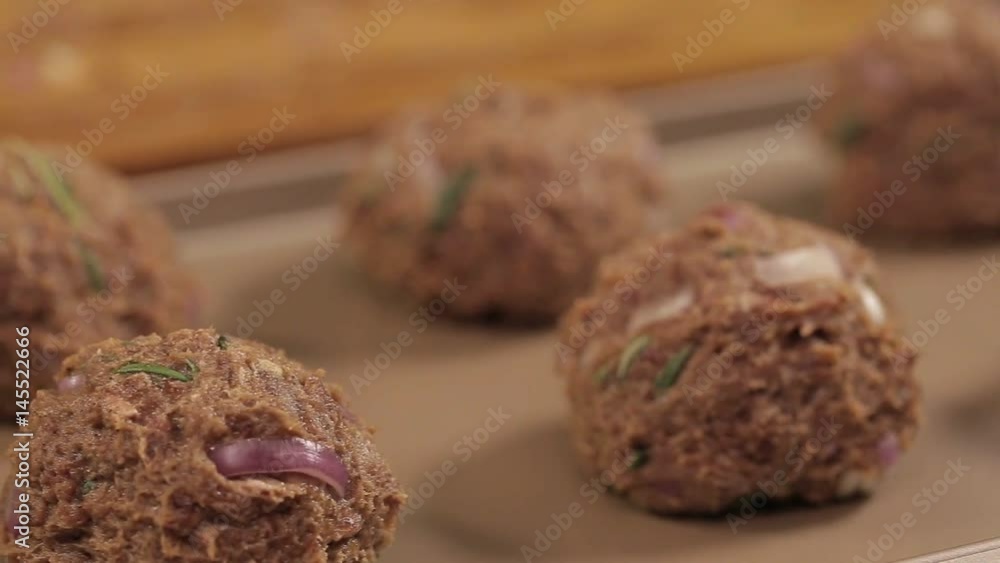 Meat Patty Mixture - Meat Balls On A Tray - Pan - Right To Left - Side Angle Meat Patty Mixture - Meat Balls On A Tray - Pan - Right To Left - Side Angle