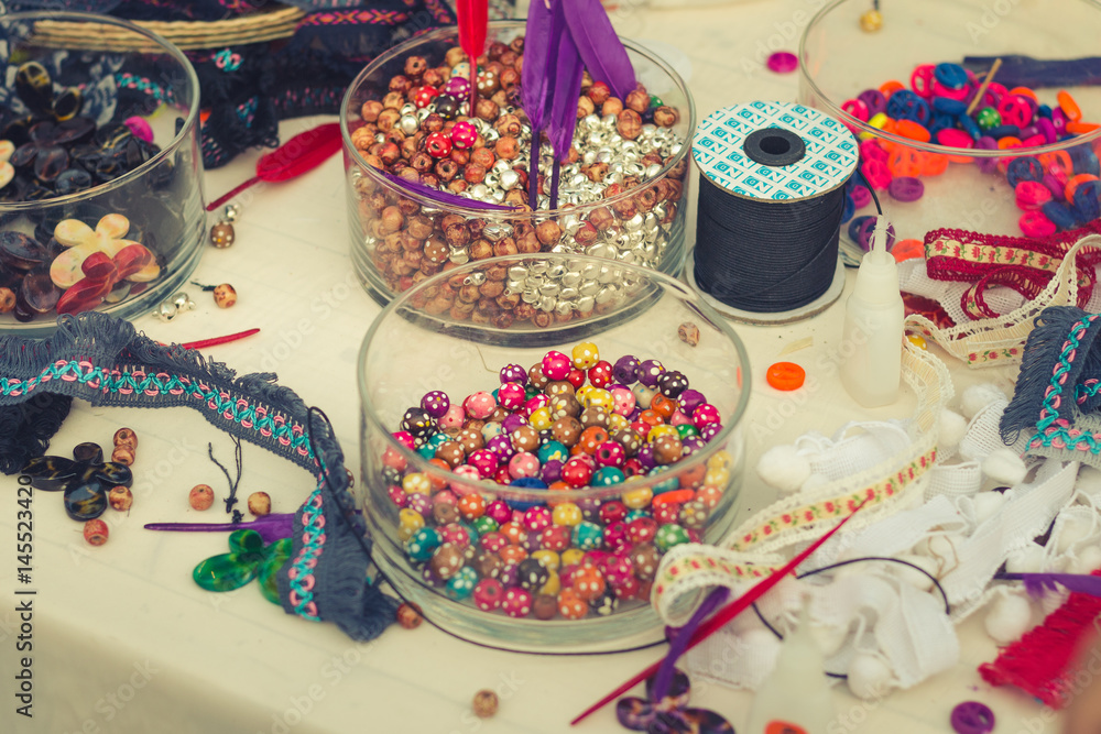 Fototapeta premium Decorate tools fabric ,bead ,small bell and feather for DIY behemian vintage style. Selective focus