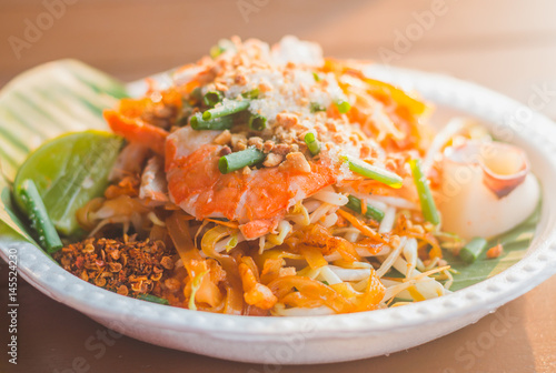 The traditional Thai food Pad Thai Noodles with shrimp and vegetables on foam dish