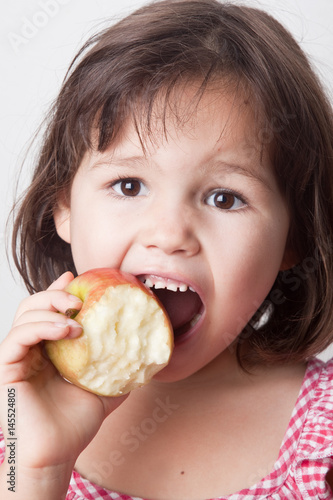 Girl biting an apple 