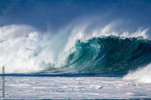 A big breaking Ocean wave on the north shore of Oahu Hawaii
