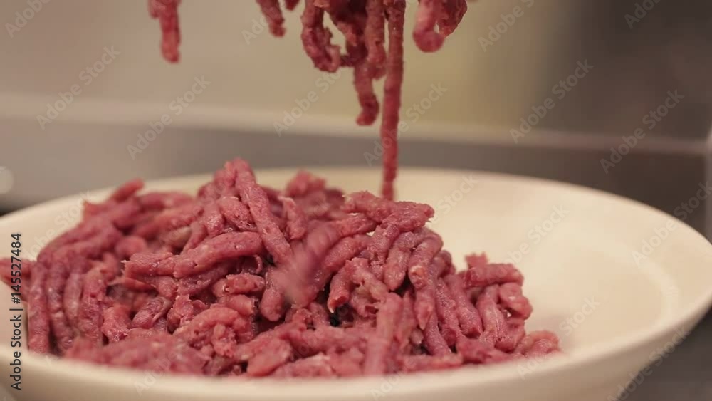Meat Mincing - Minced Beef Coming Out - Front Angle - Tilt - Top To Bottom Meat Mincing - Minced Beef Coming Out - Front Angle - Tilt - Top To Bottom