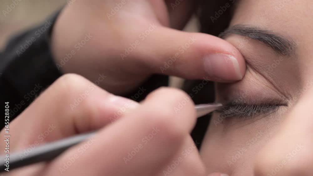 Putting the eye shadow on the eyelids- close up Putting the eye shadow on the eyelids- close up