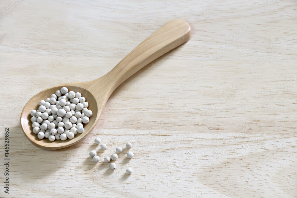 Peppercorns in spoon wood on wooden. Peppercorns in spoon wood on wooden.