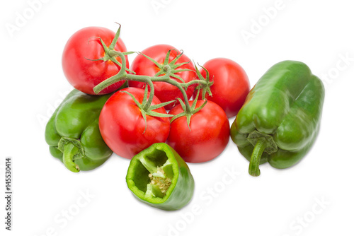 Branch of the ripe red tomatoes and green bell peppers