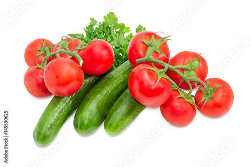 Cucumbers and two branches of the ripe red tomatoes